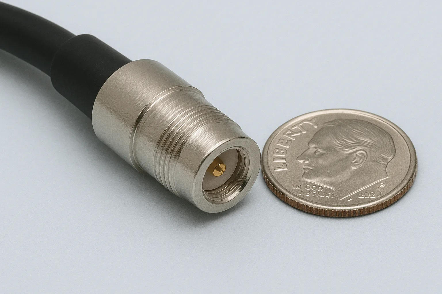 FME female connector next to a coin for size reference