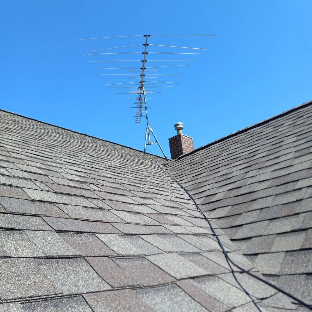 Rooftop antenna and coaxial cable installed along the house wall