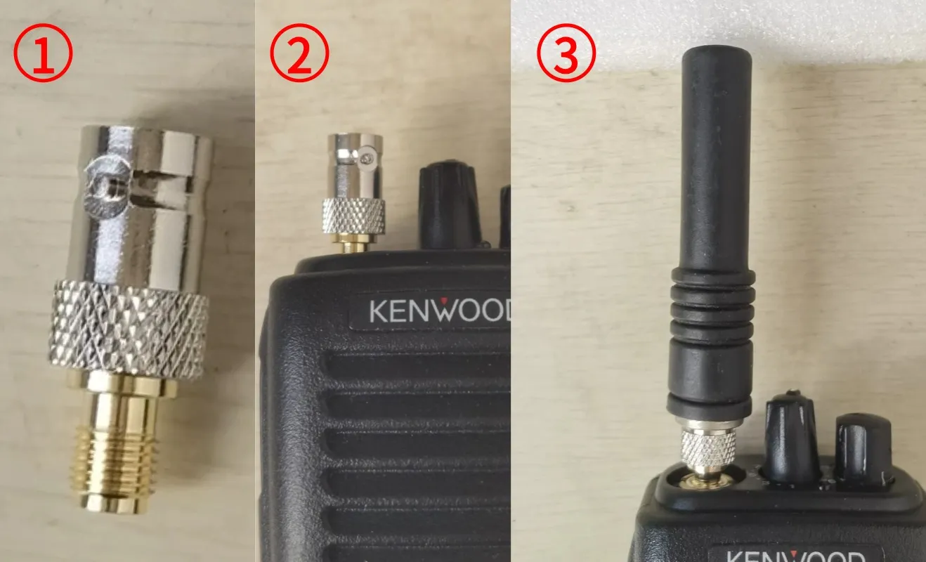 A hand installing an SMA male to BNC female adapter onto the BNC port of a software-defined radio (SDR) or test equipment
