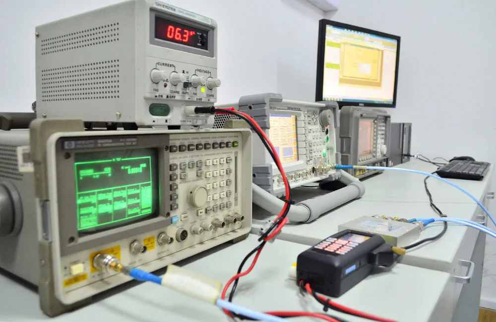 An engineer in a lab uses a Vector Network Analyzer to test the S-parameters of a 50-Ohm BNC cable.