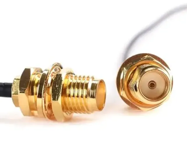 SMA bulkhead feedthrough on a metal panel with nut, washer, and O-ring; correct thread engagement and grounding