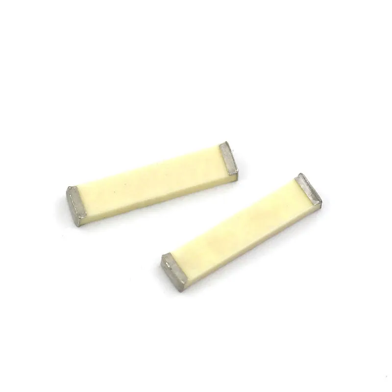 Close-up of a miniature ceramic chip antenna, showing its extremely compact surface-mount package.