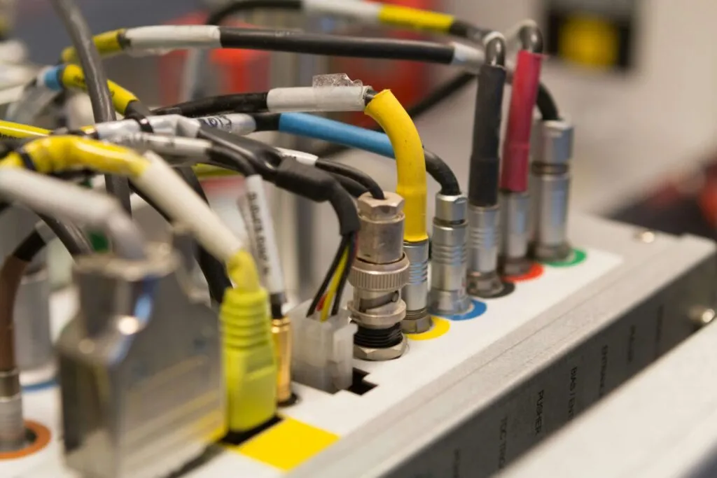 An illustration showing best practices for strain relief, routing, and anti-kink techniques behind a panel for SMA extension cables. An illustration showing best practices for strain relief, routing, and anti-kink techniques behind a panel for SMA extension cables.