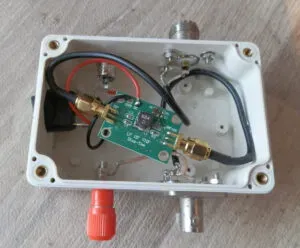 A photo showing a spectrum analyzer or VNA with a short SMA Male-to-Female cable permanently attached to its front-panel connector. A worn-out or damaged similar cable is shown nearby for contrast, emphasizing the “sacrificial” role. A photo showing a spectrum analyzer or VNA with a short SMA Male-to-Female cable permanently attached to its front-panel connector. A worn-out or damaged similar cable is shown nearby for contrast, emphasizing the “sacrificial” role.