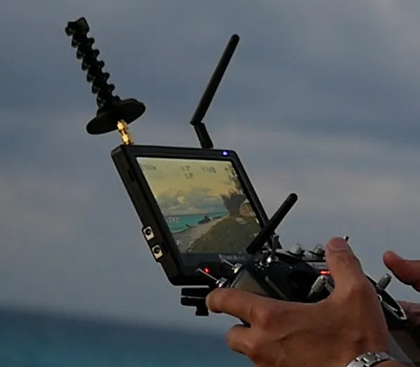 Small FPV drone on a workbench with a 5.8GHz antenna mounted on the VTX, ready for testing Small FPV drone on a workbench with a 5.8GHz antenna mounted on the VTX, ready for testing