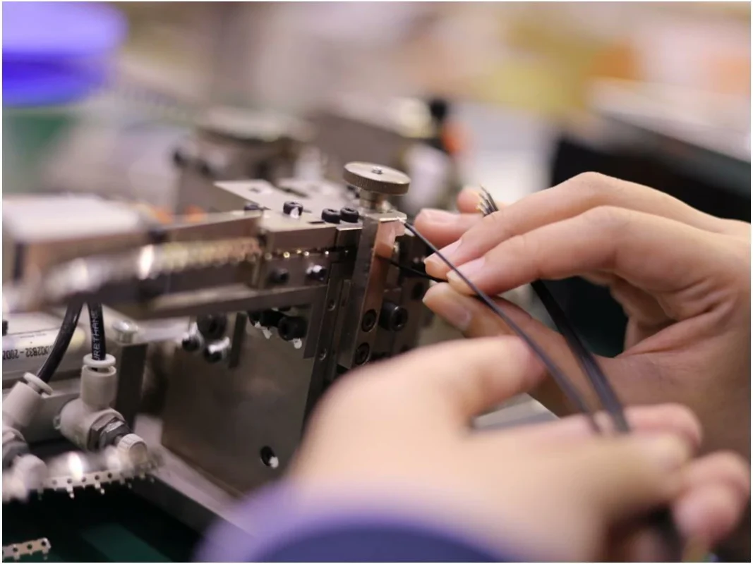Technician assembling a custom RF coaxial cable connector Technician assembling a custom RF coaxial cable connector