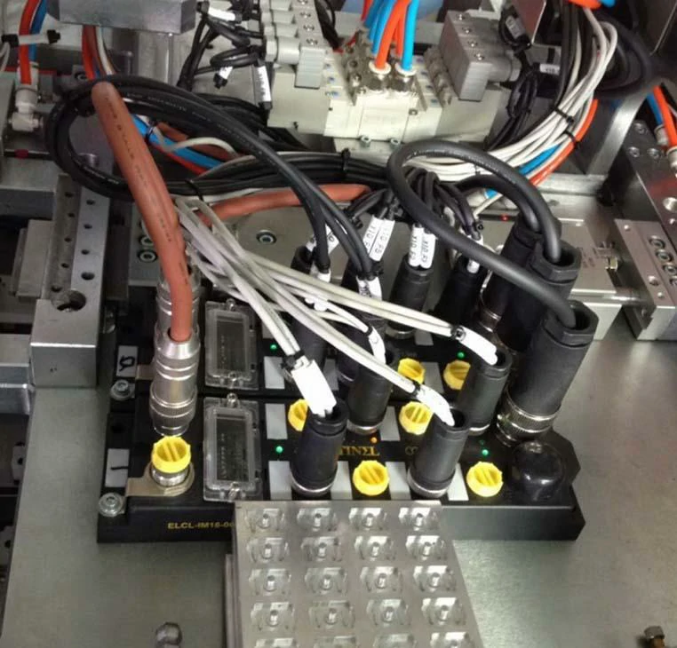 Multiple GX16-style circular connectors installed in industrial automation equipment Multiple GX16-style circular connectors installed in industrial automation equipment