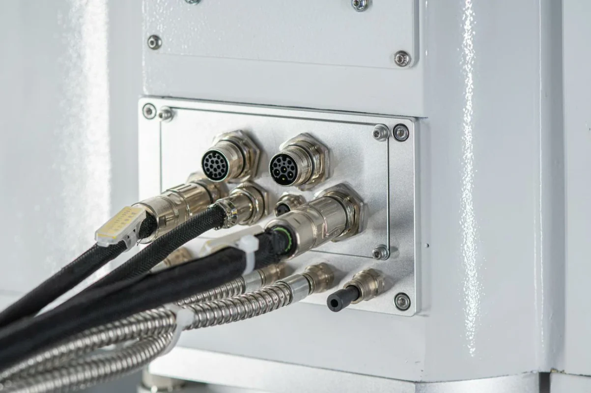 Multiple GX16-style multi-pin connectors installed on an industrial machine interface panel Multiple GX16-style multi-pin connectors installed on an industrial machine interface panel