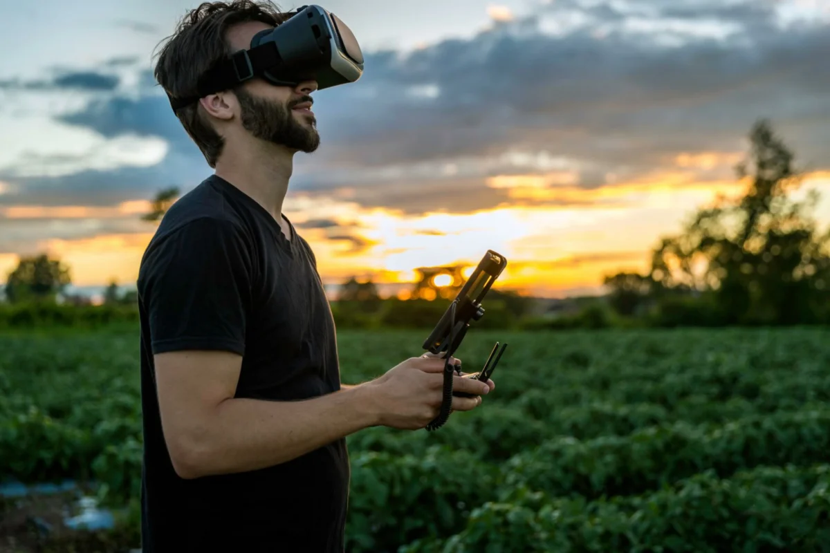 Pilot wearing FPV goggles and operating a drone outdoors Pilot wearing FPV goggles and operating a drone outdoors