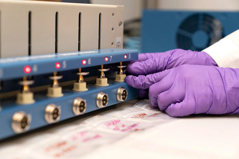 Technician inspecting RF connectors during production testing Technician inspecting RF connectors during production testing