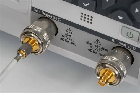 Gold-plated SMA male connector installed on a black 50-ohm coaxial cable Gold-plated SMA male connector installed on a black 50-ohm coaxial cable