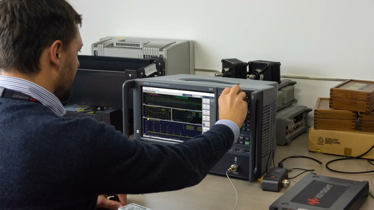 Engineer using a VNA to verify S11 and S21 performance of an RF test cable Engineer using a VNA to verify S11 and S21 performance of an RF test cable