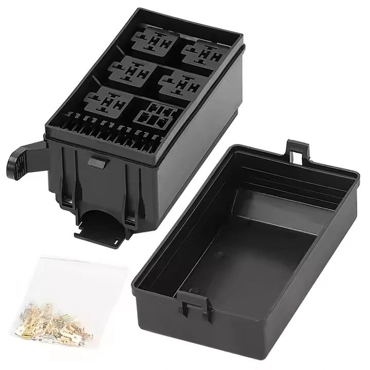 Empty automotive fuse relay box housing with protective cover and loose terminals for custom harness assembly. Empty automotive fuse relay box housing with protective cover and loose terminals for custom harness assembly.