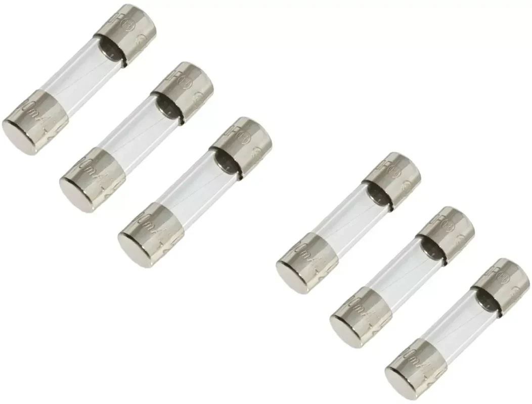 Glass fuse cartridges arranged for size comparison and electrical fuse replacement selection Glass fuse cartridges arranged for size comparison and electrical fuse replacement selection