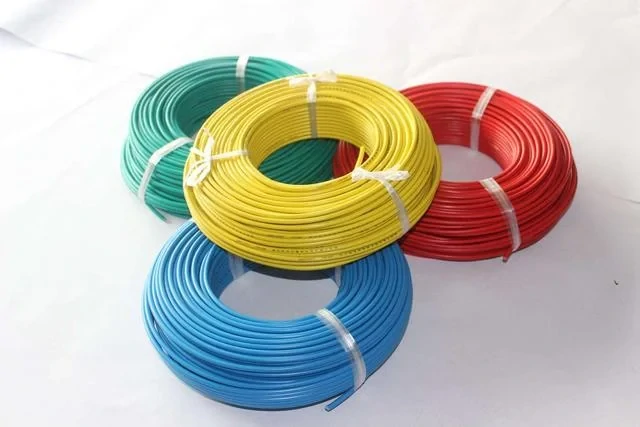 Coils of red, yellow, green, and blue insulated electrical wire Coils of red, yellow, green, and blue insulated electrical wire
