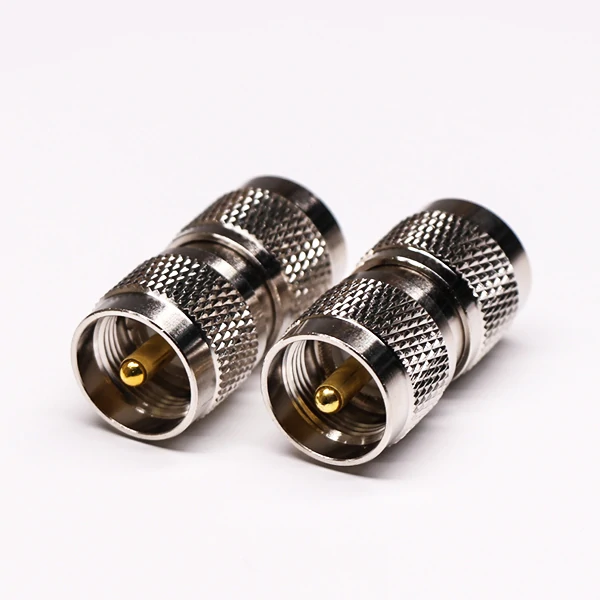 Two PL-259 UHF male-to-male coaxial adapters with knurled metal bodies Two PL-259 UHF male-to-male coaxial adapters with knurled metal bodies