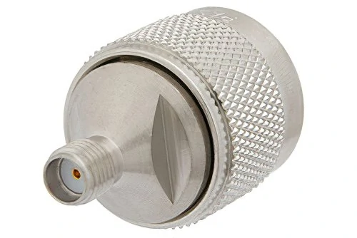 Close-up of a threaded SMA connector interface mounted on a large knurled metal body Close-up of a threaded SMA connector interface mounted on a large knurled metal body