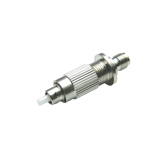 Close-up of a threaded metal connector adapter with a knurled body and protruding ceramic ferrule Close-up of a threaded metal connector adapter with a knurled body and protruding ceramic ferrule