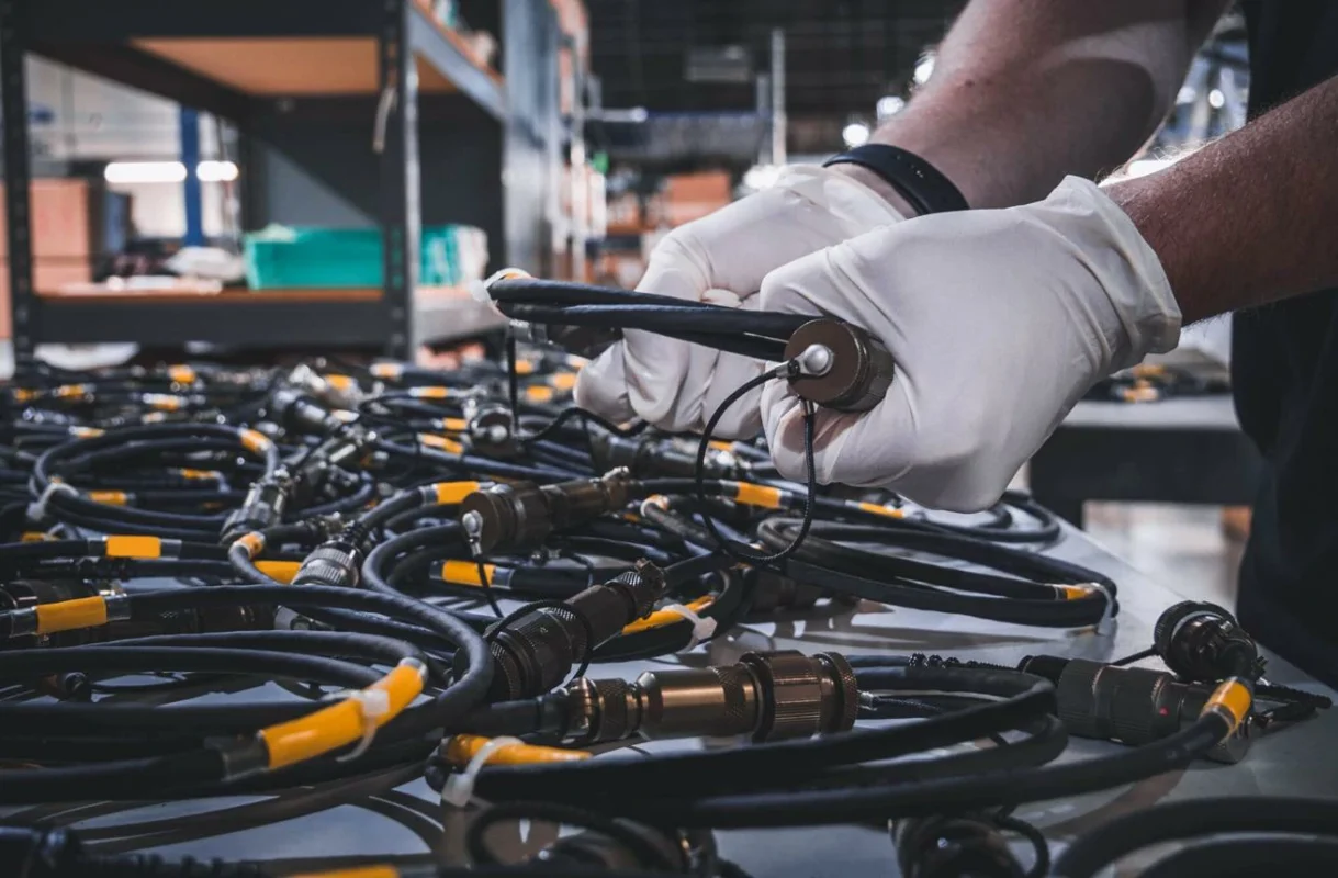 Technician inspecting antenna cable assemblies for RF connection quality Technician inspecting antenna cable assemblies for RF connection quality